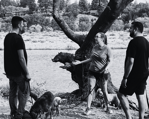Terra with a group instructing people with several dogs on leash for the movie Mickey Tree