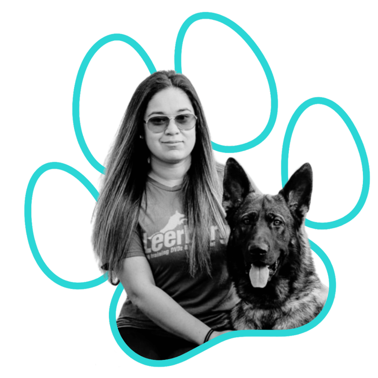 Black and white photo of Alex sitting with a German Shepherd inside a paw print outline