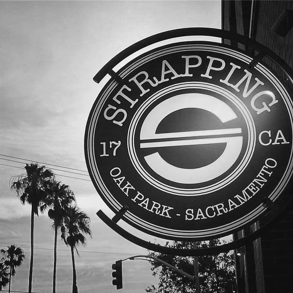 Street Rapping sign in Oak Park, Sacramento, California with palm trees and traffic lights in the background
