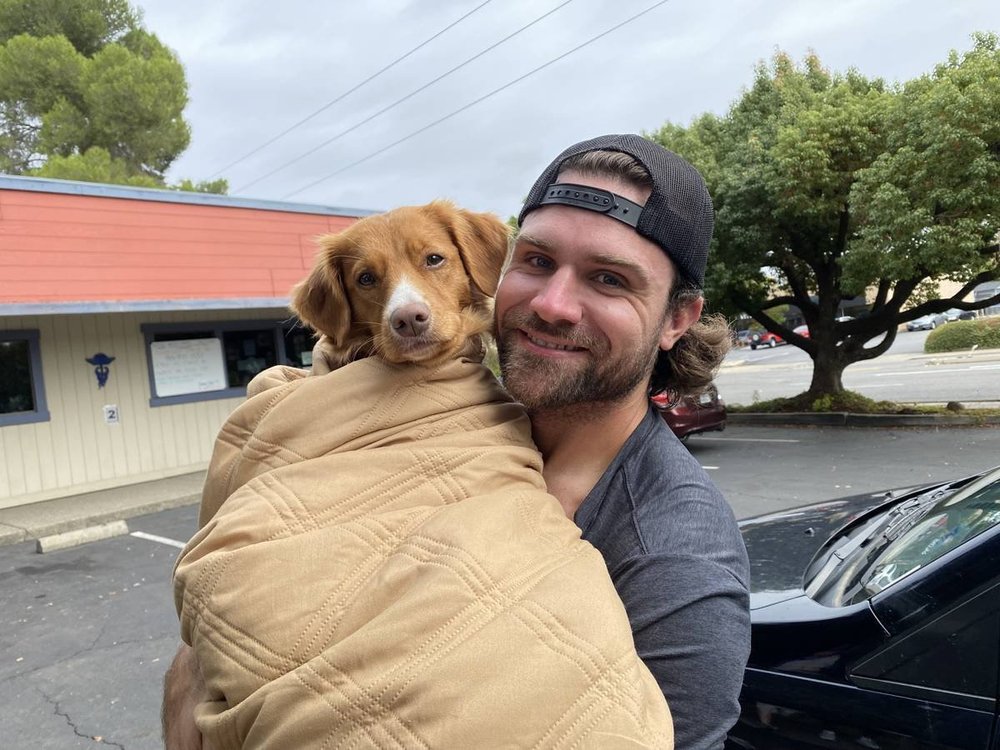 Maisey, the dog from the film Mickey's Tree, with her dad Zach outside Reagor Pet Hospital in Carmichael