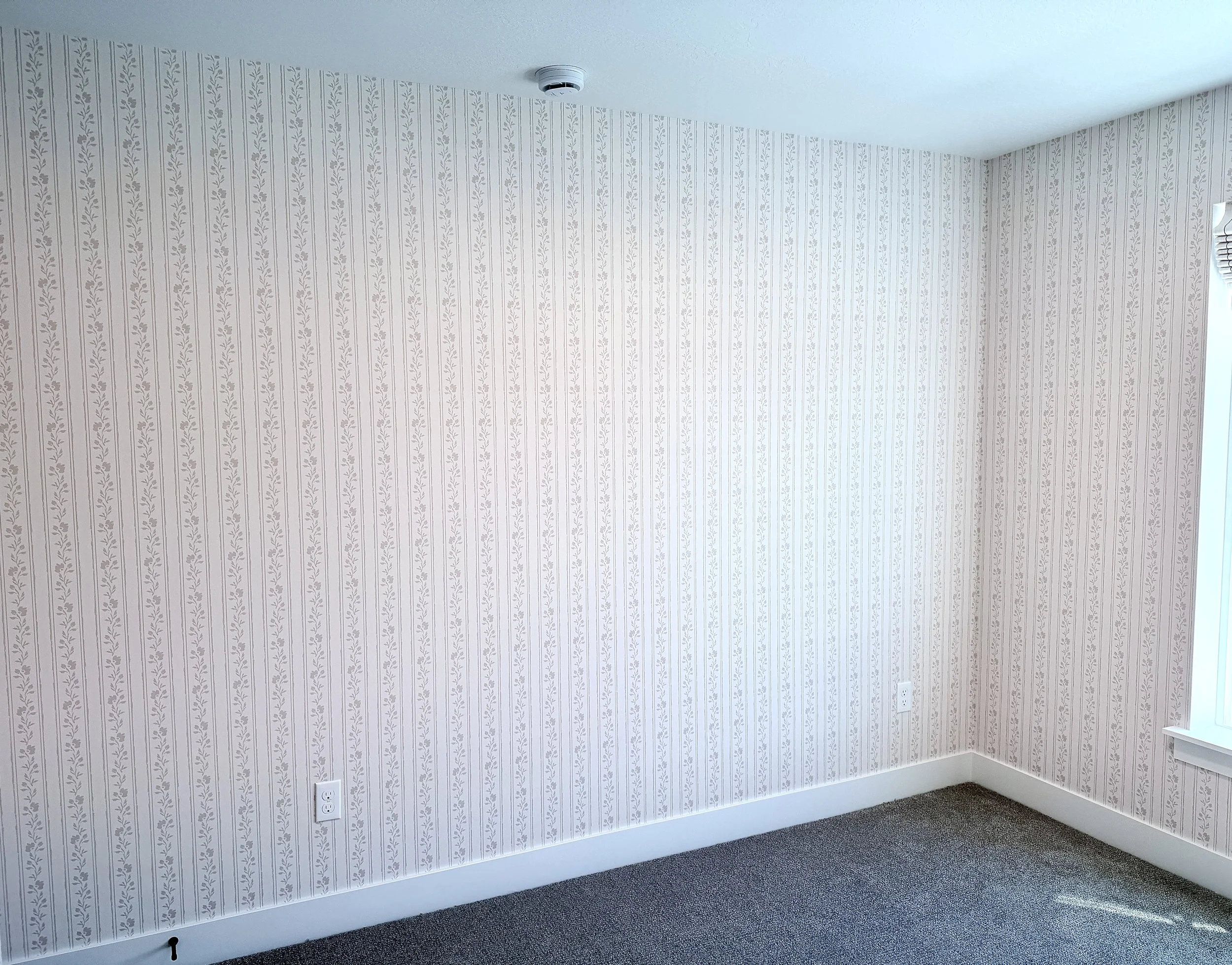 Soft blush pink floral striped wallpaper for baby girl nursery.