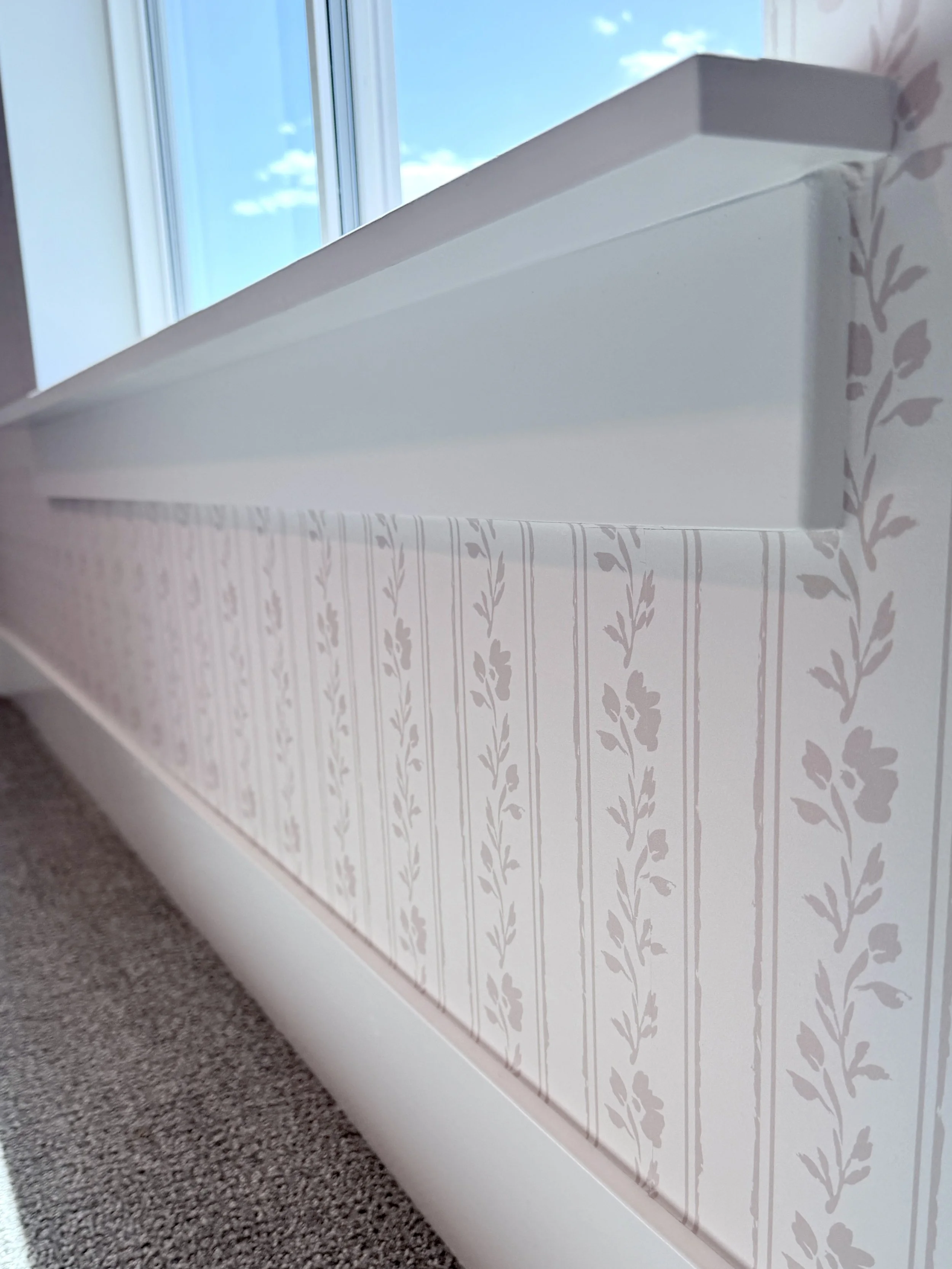 Soft blush pink floral striped wallpaper for baby girl nursery.