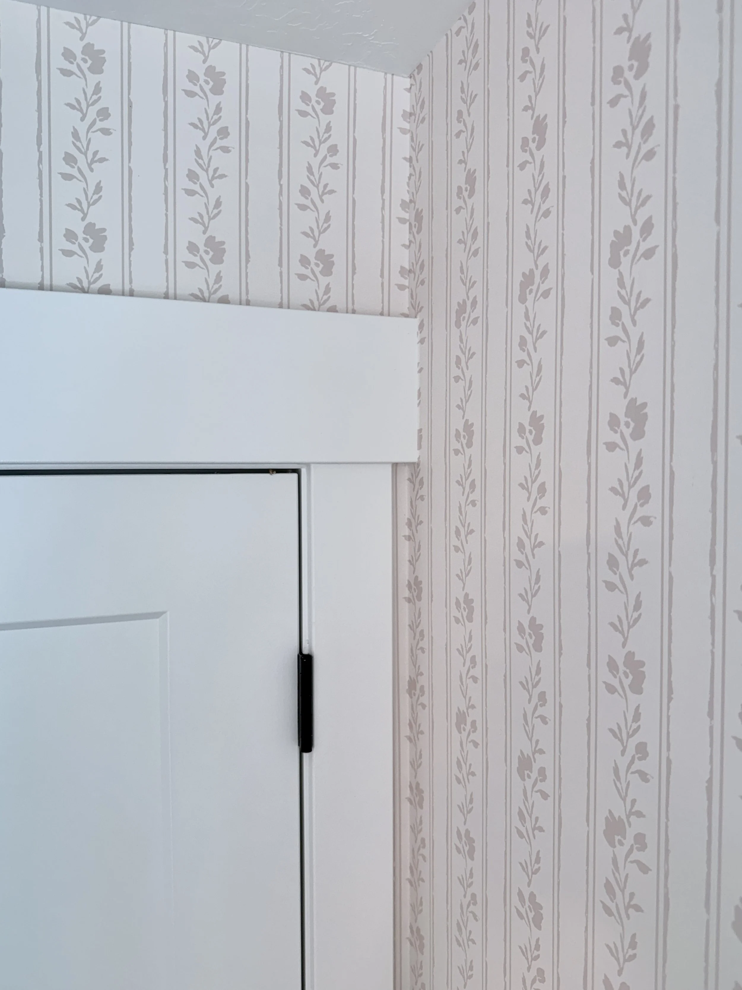 Soft blush pink floral striped wallpaper for baby girl nursery.