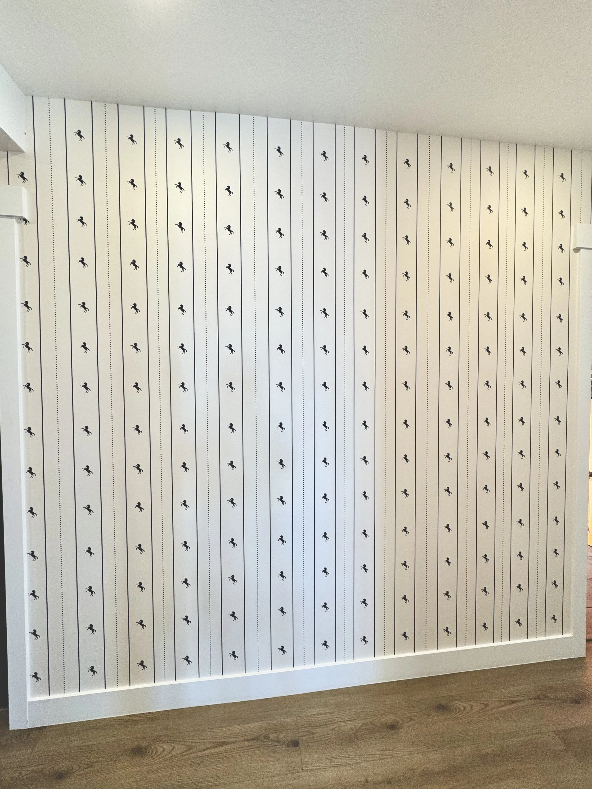 I'm Not Too Western Green Horse Wallpaper by The Torrie Jarrett Line Wall Blush wallpaper installation in a hallway with black interior doors