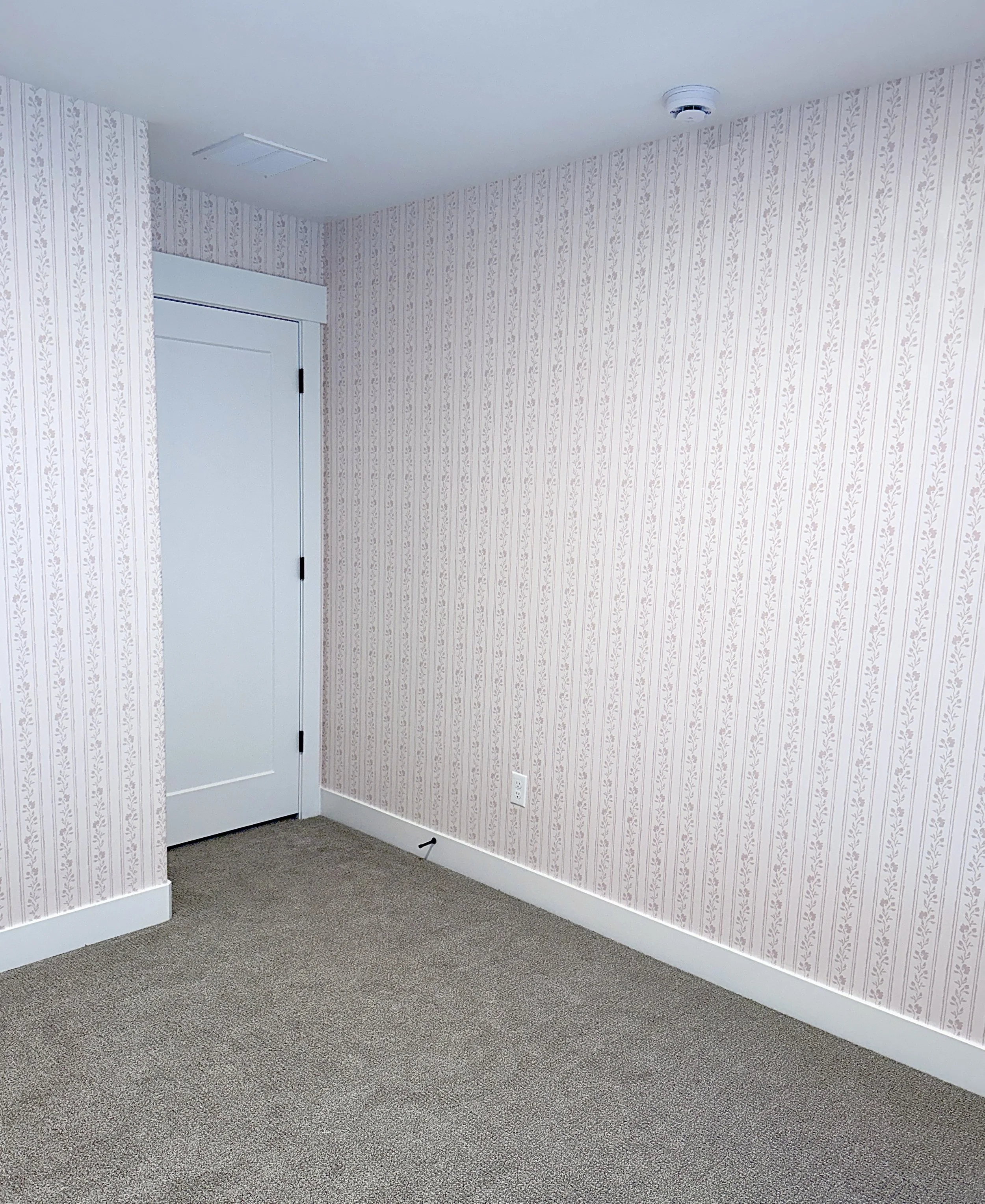 Soft blush pink floral striped wallpaper for baby girl nursery.