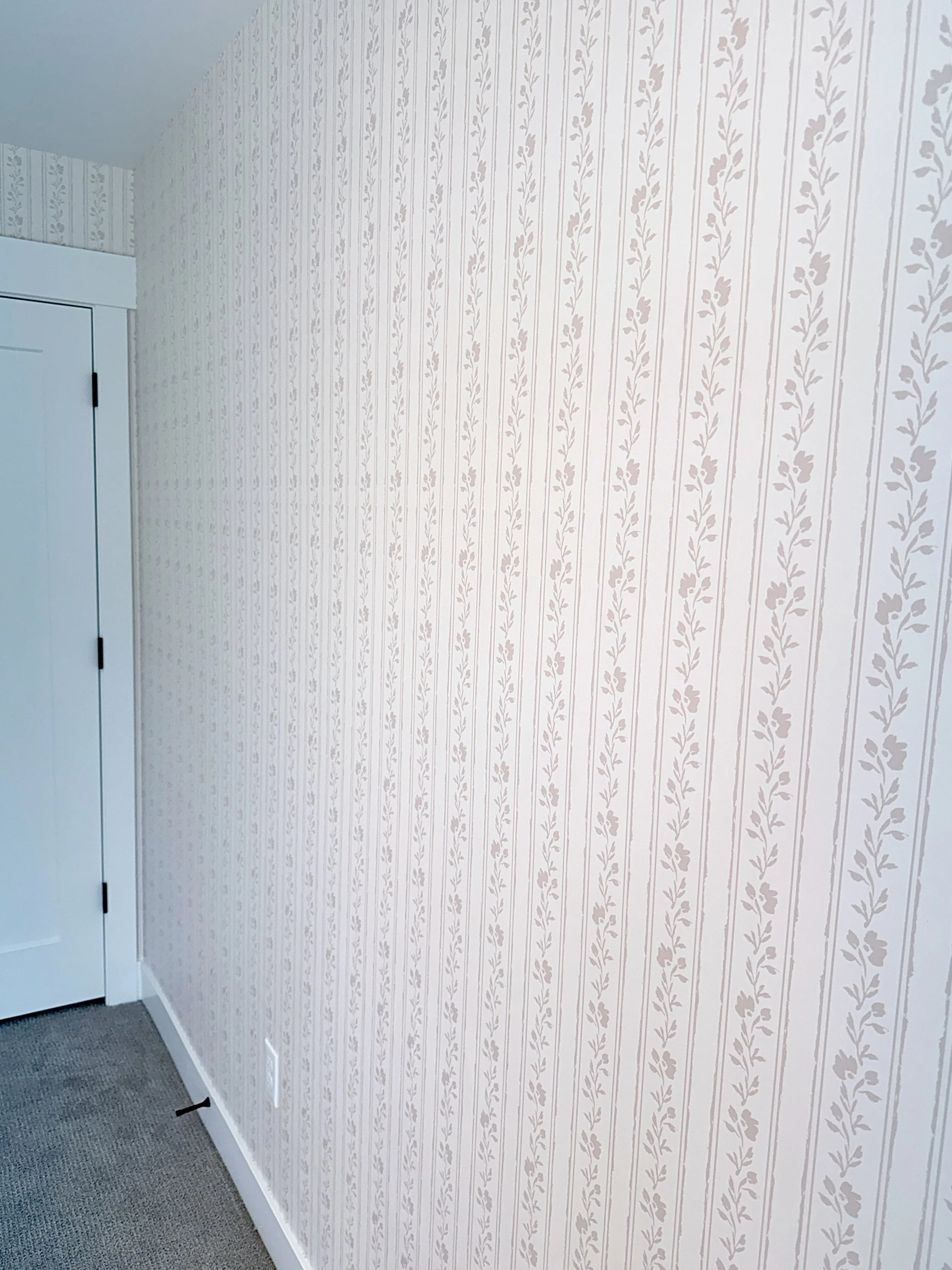 Soft blush pink floral striped wallpaper for baby girl nursery.