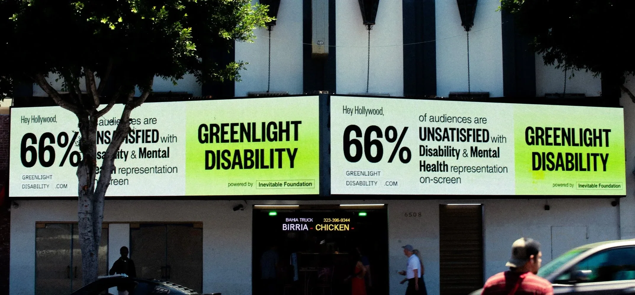 A billboard that reads, "Hey Hollywood, 66% of audiences are unsatisfied with disability & mental health representation on-screen. Greenlight disability." The billboard is a variety of shades of green and the text is black.