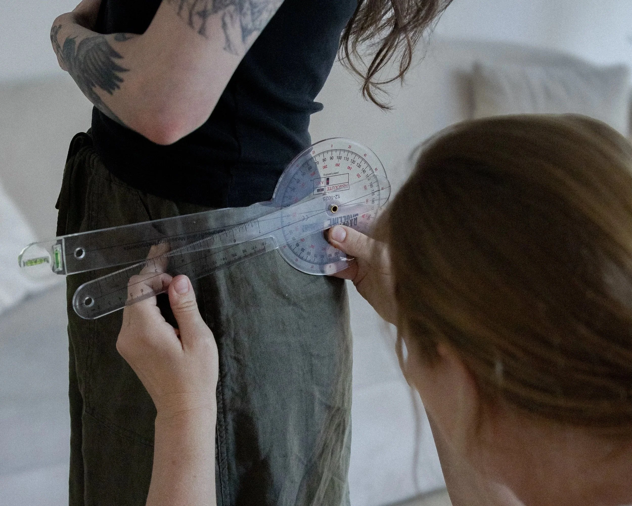 Jessie Gunther measures a clients hips before beginning a massage