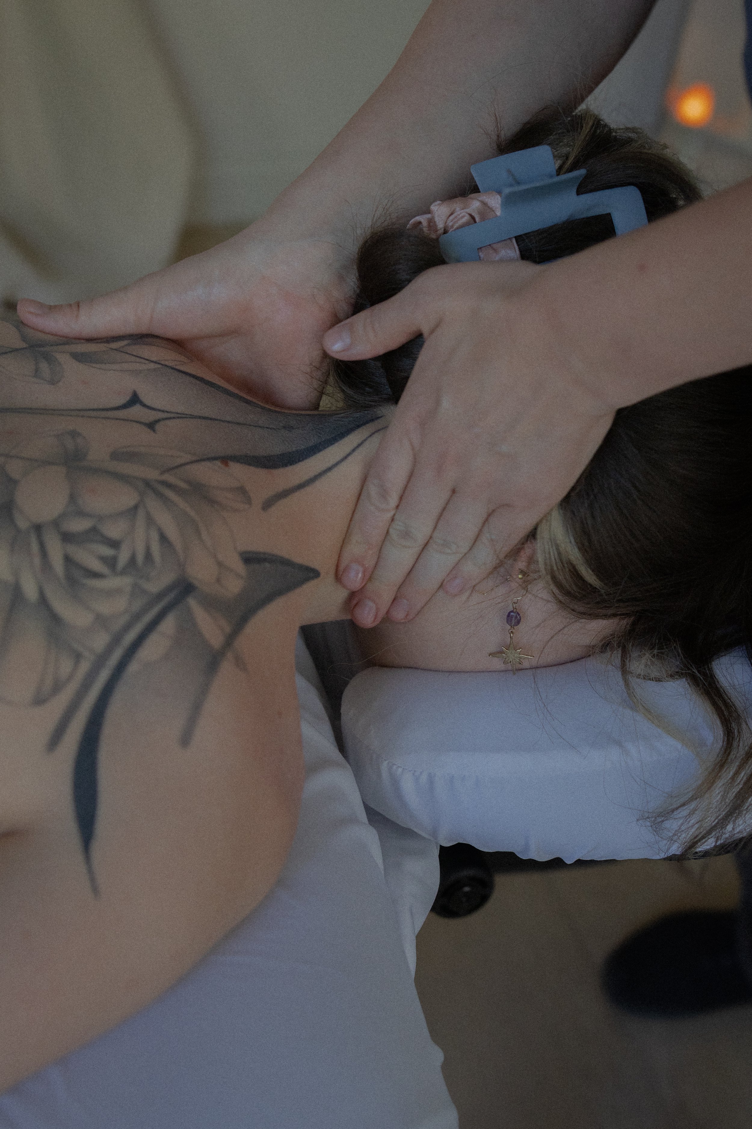 Jessie Gunther massaging a clients neck and shoulder