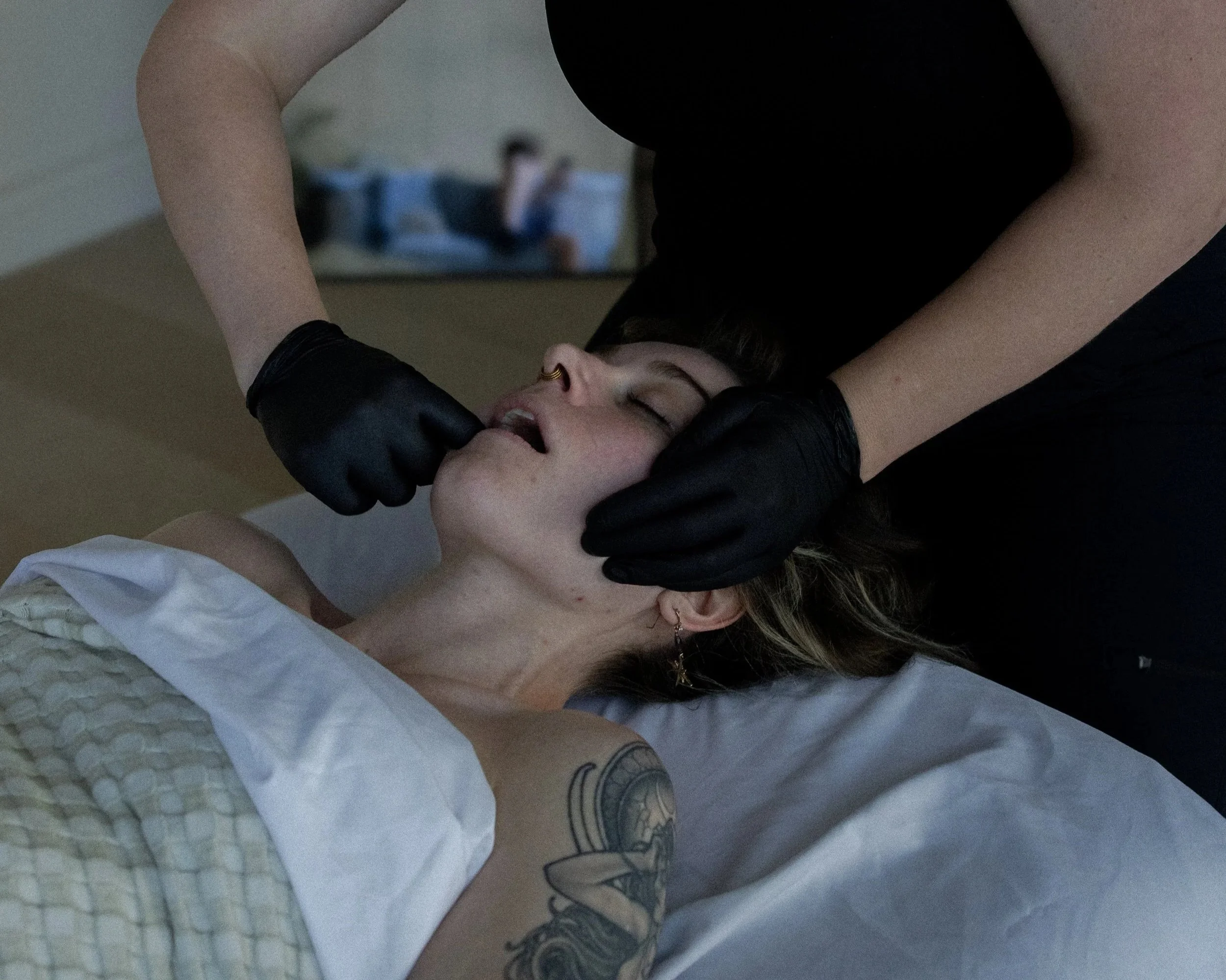 Jessie Gunther giving a client an inter oral massage for TMJ pain relief