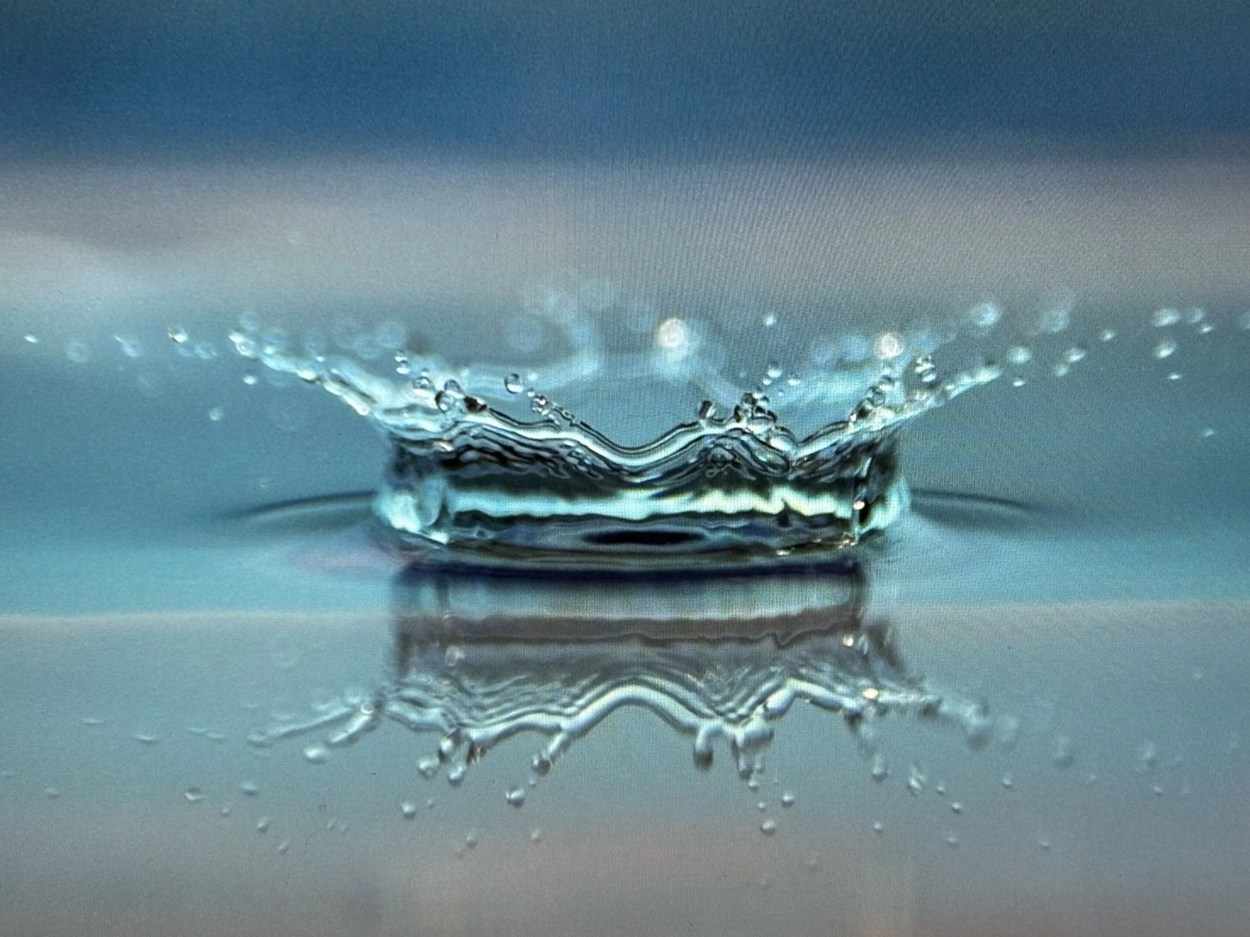 Close-up of a water splash creating ripples and bubbles on the surface.