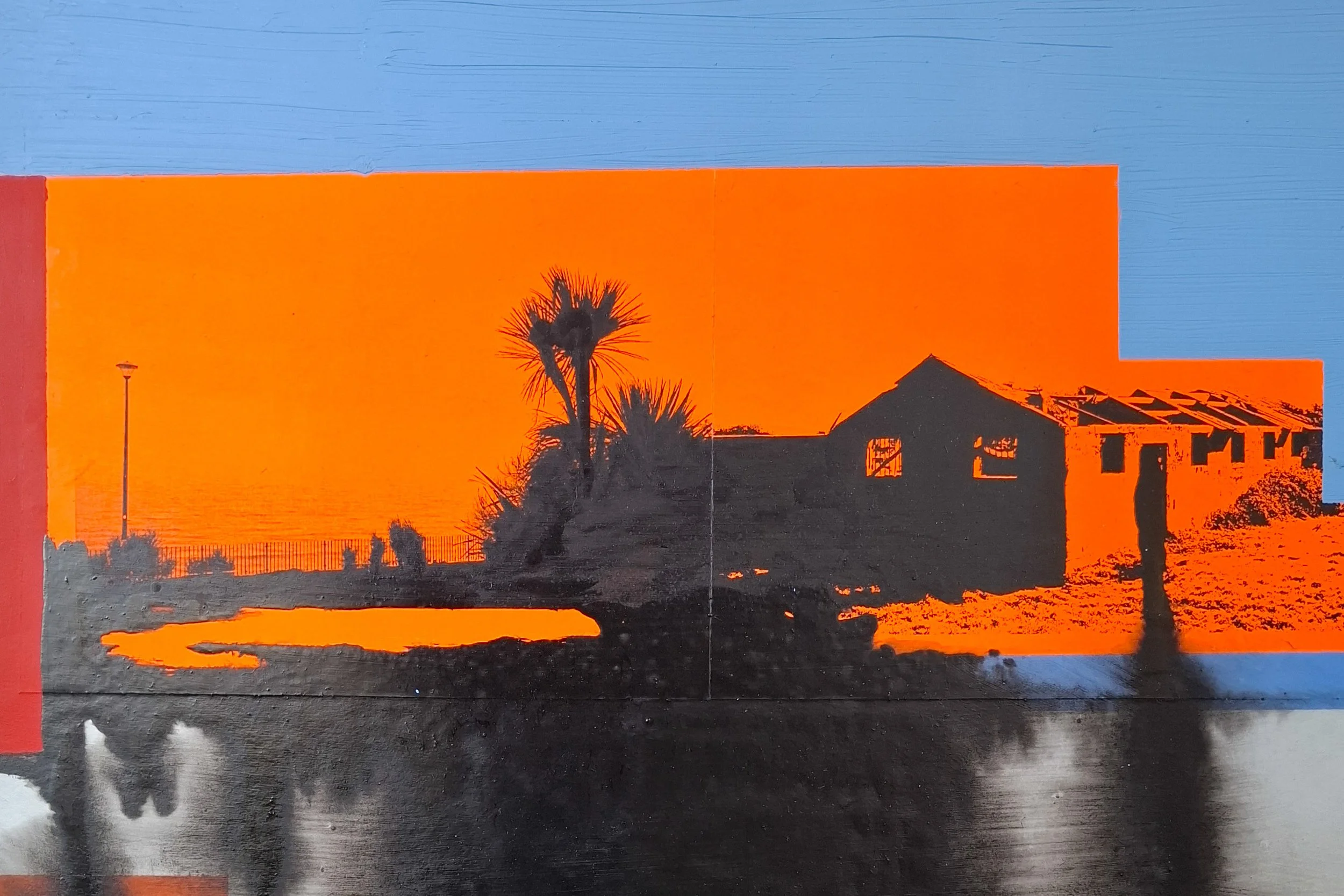 Silhouette of trees and buildings during sunset with an orange sky and blue top