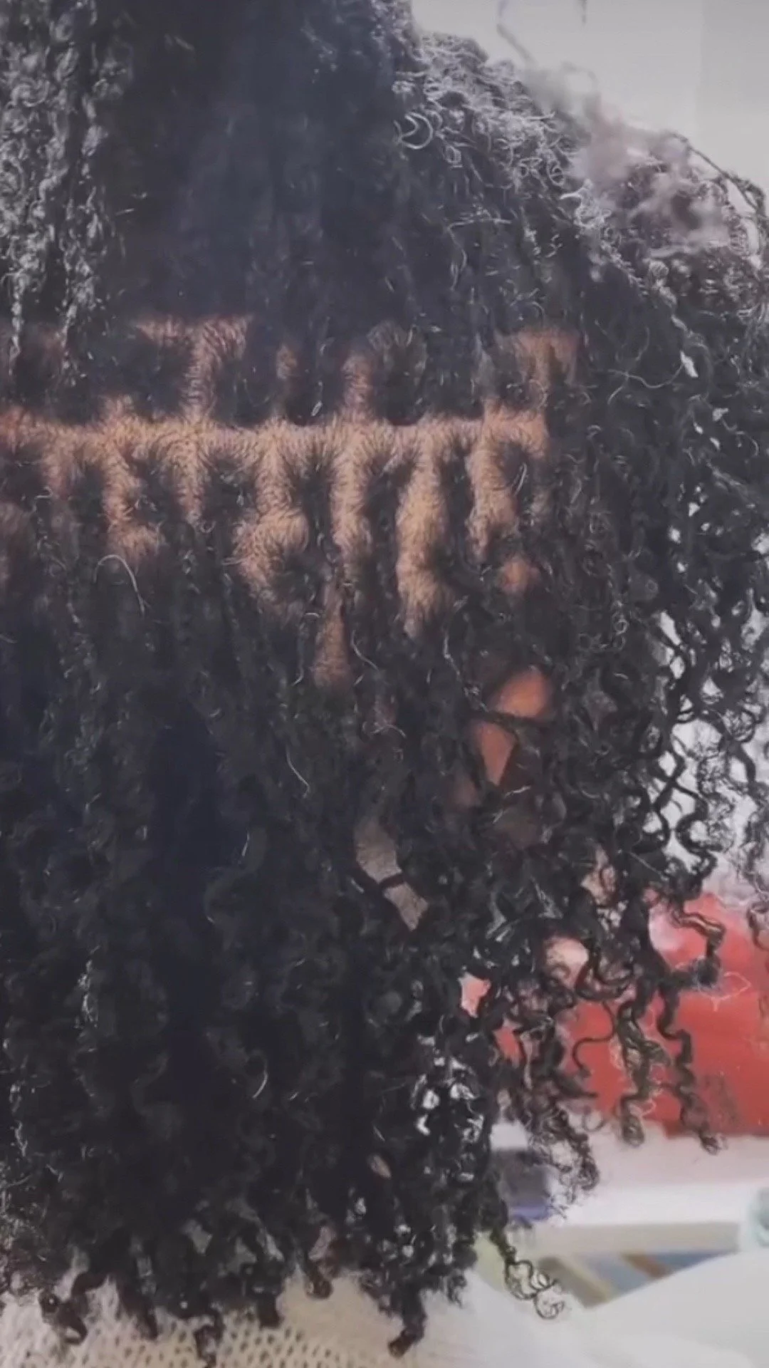 Close-up of wet, curly black hair.