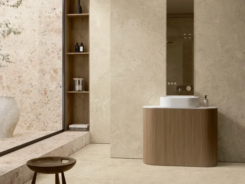 Modern beige bathroom featuring Ariostea Portland stone-effect ceramic surfaces designed to evoke historical textures, supplied and installed nationwide by PietraCasa.