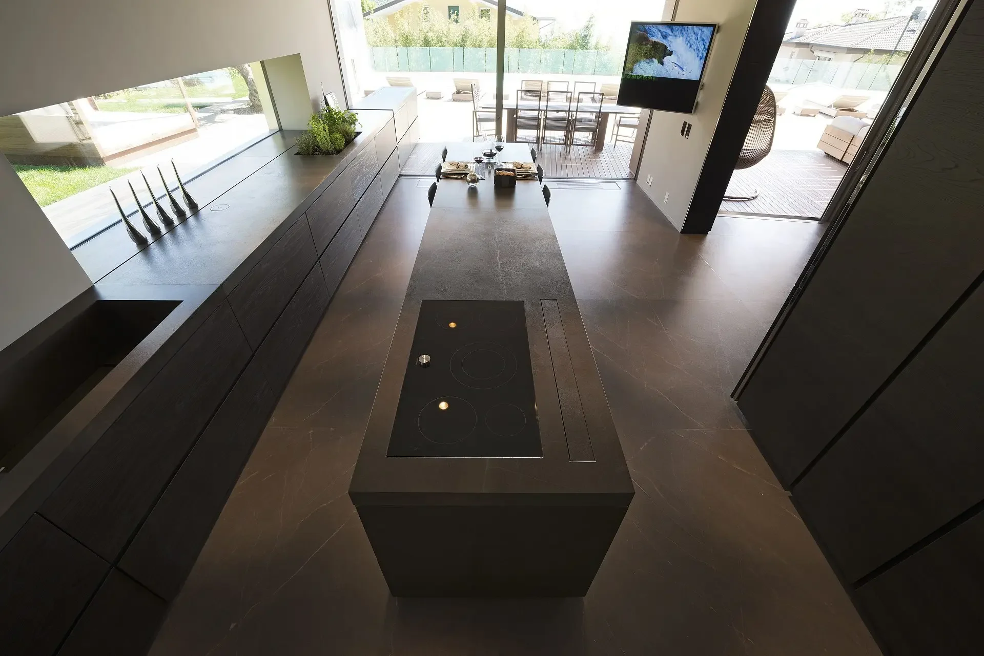 Luxurious, minimalist kitchen featuring premium natural stone surfaces from Antolini, supplied by PietraCasa.