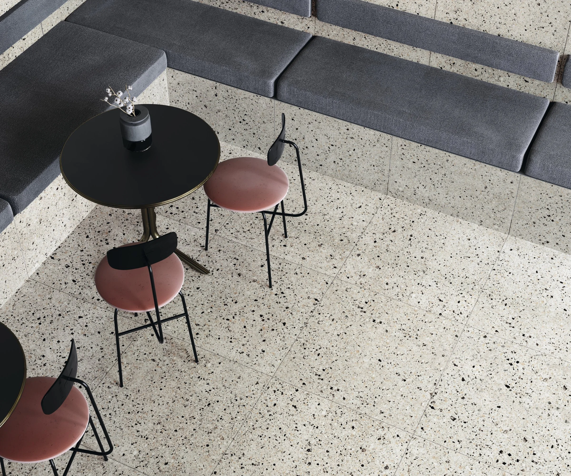 Interior seating area featuring FMG Rialto Pink, a classic terrazzo-style porcelain tile with a soft, light-toned base and varied dark and polychrome specks, expertly supplied and installed by PietraCasa.