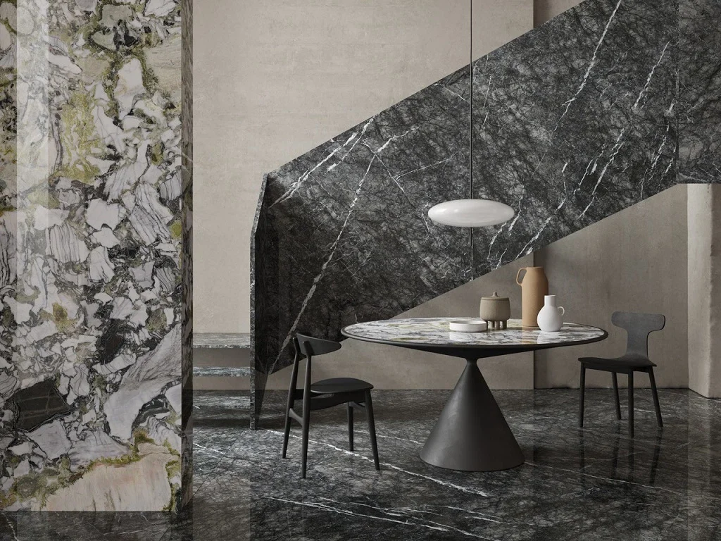 Luxury architectural interior featuring Ariostea Ultra Marmi porcelain stoneware surfaces in a polished finish, mimicking natural Grigio Carnico marble, and an Adrien coffee table with a stone top, supplied and installed nationwide by PietraCasa.