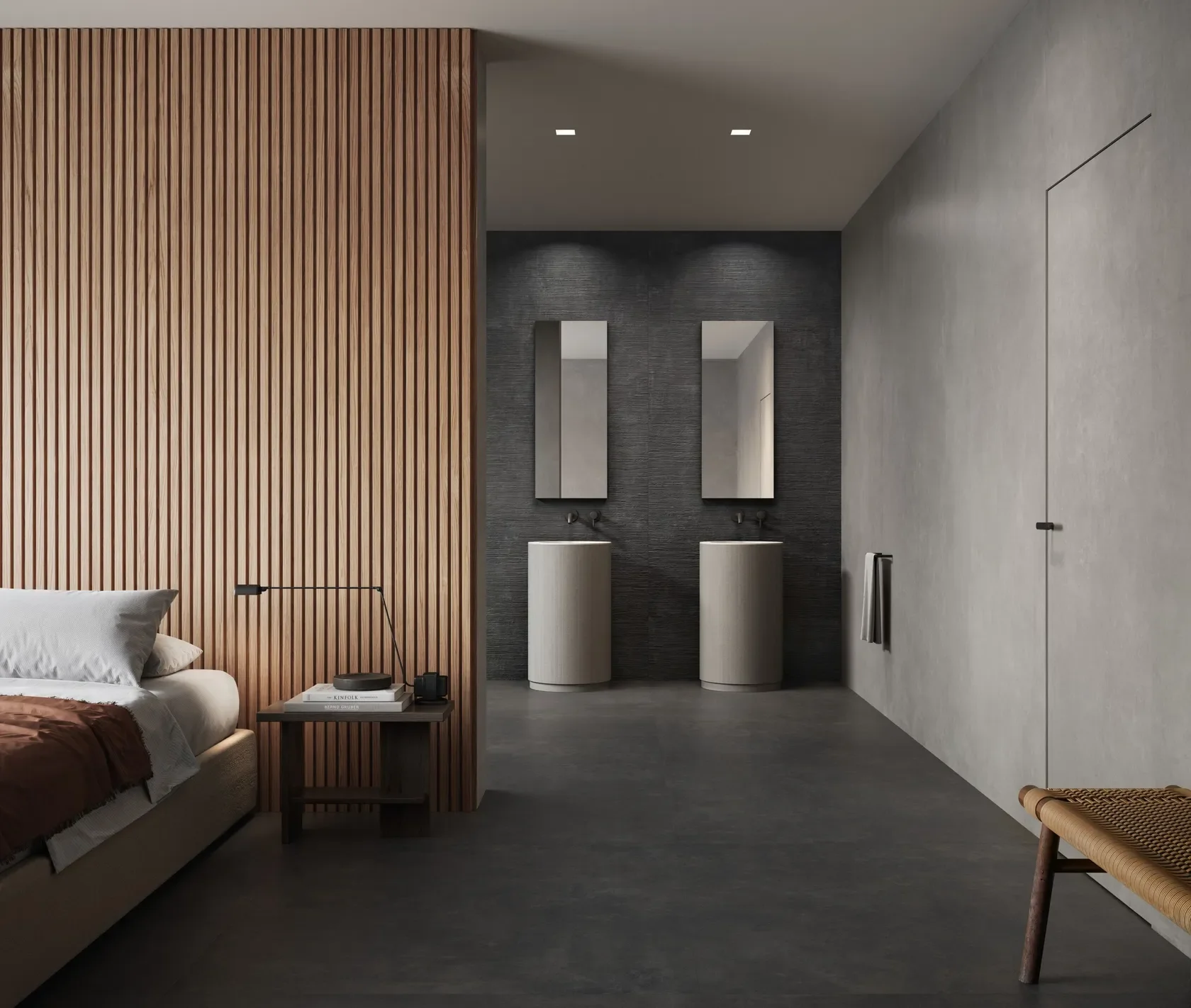 High-end bedroom-to-bathroom suite featuring Impronta Ceramiche Concrete Black porcelain tiles, paired with striking fluted timber wall paneling and dual modern pedestal sinks, supplied by PietraCasa.