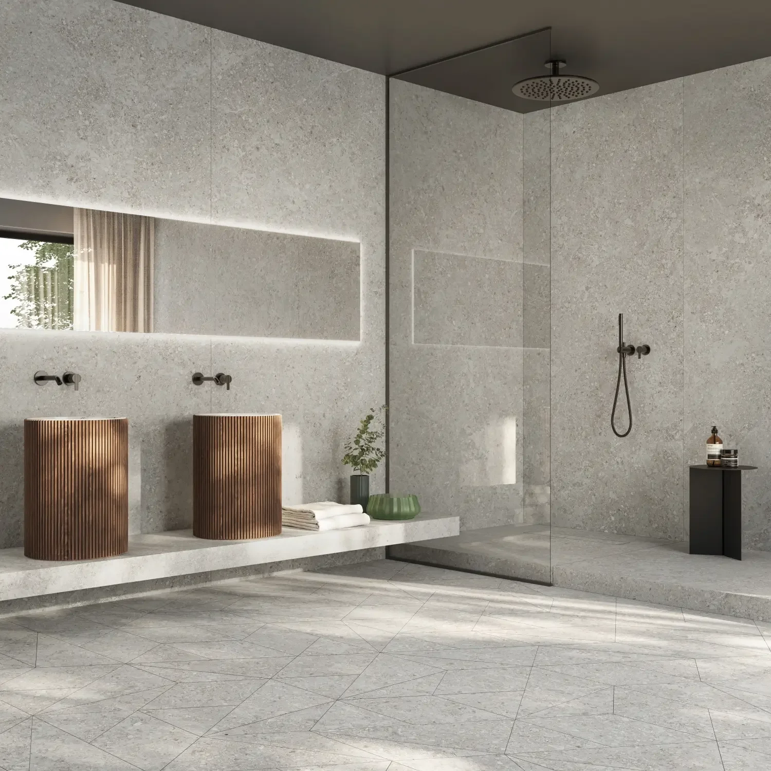 Sleek, contemporary bathroom featuring the Cobb natural stone-inspired porcelain tiles by Ceramiche Supergres, showcasing dual fluted pedestal sinks, an expansive backlit LED mirror, and a seamless walk-in shower, supplied by PietraCasa.