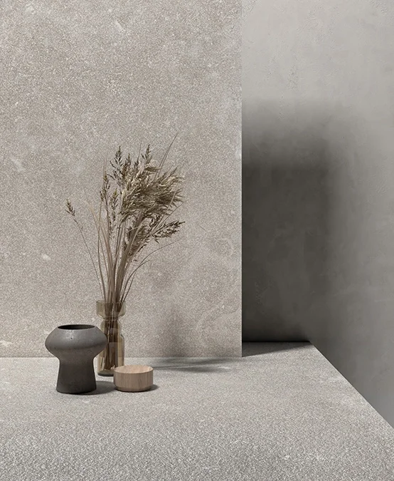 A serene, minimalist setup showcasing the Evolution collection by Kronos Ceramiche, a series of porcelain stoneware tiles inspired by Nordic natural stone, available through PietraCasa.
