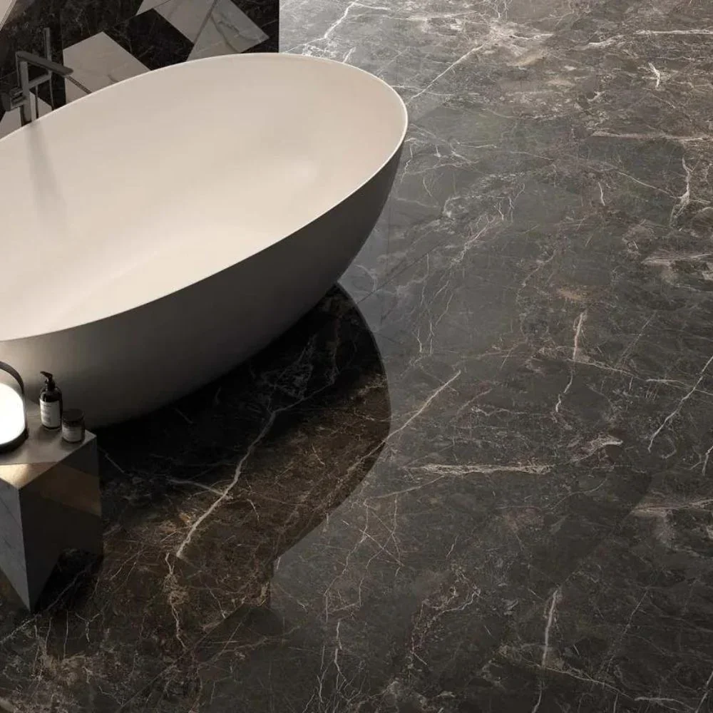 Luxurious bathroom flooring featuring Mutina Noir polished marble-effect black porcelain tiles, characterized by intricate light veining and a highly reflective finish, available through PietraCasa.