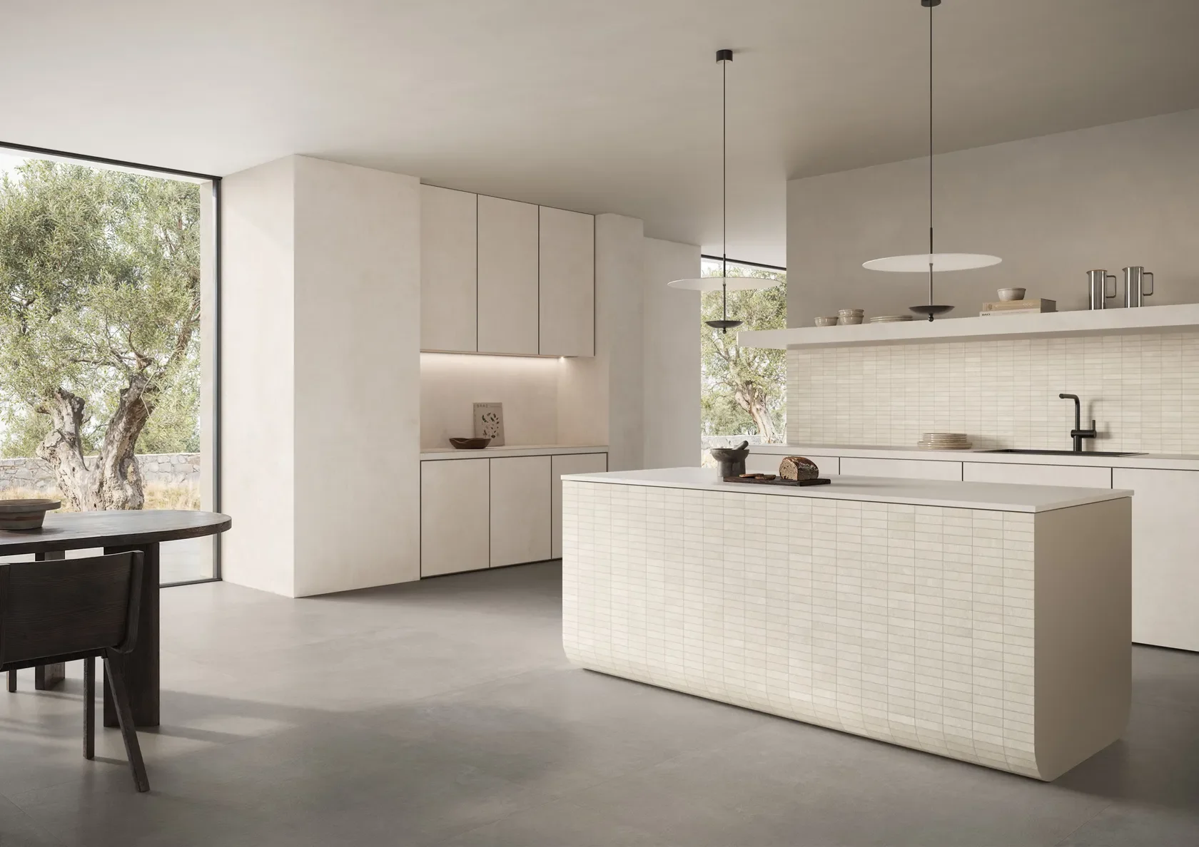 Modern kitchen design featuring a curved island and backsplash clad in textured mosaic-strip porcelain tiles from the Impronta Concrete collection by Italgraniti, supplied by PietraCasa.