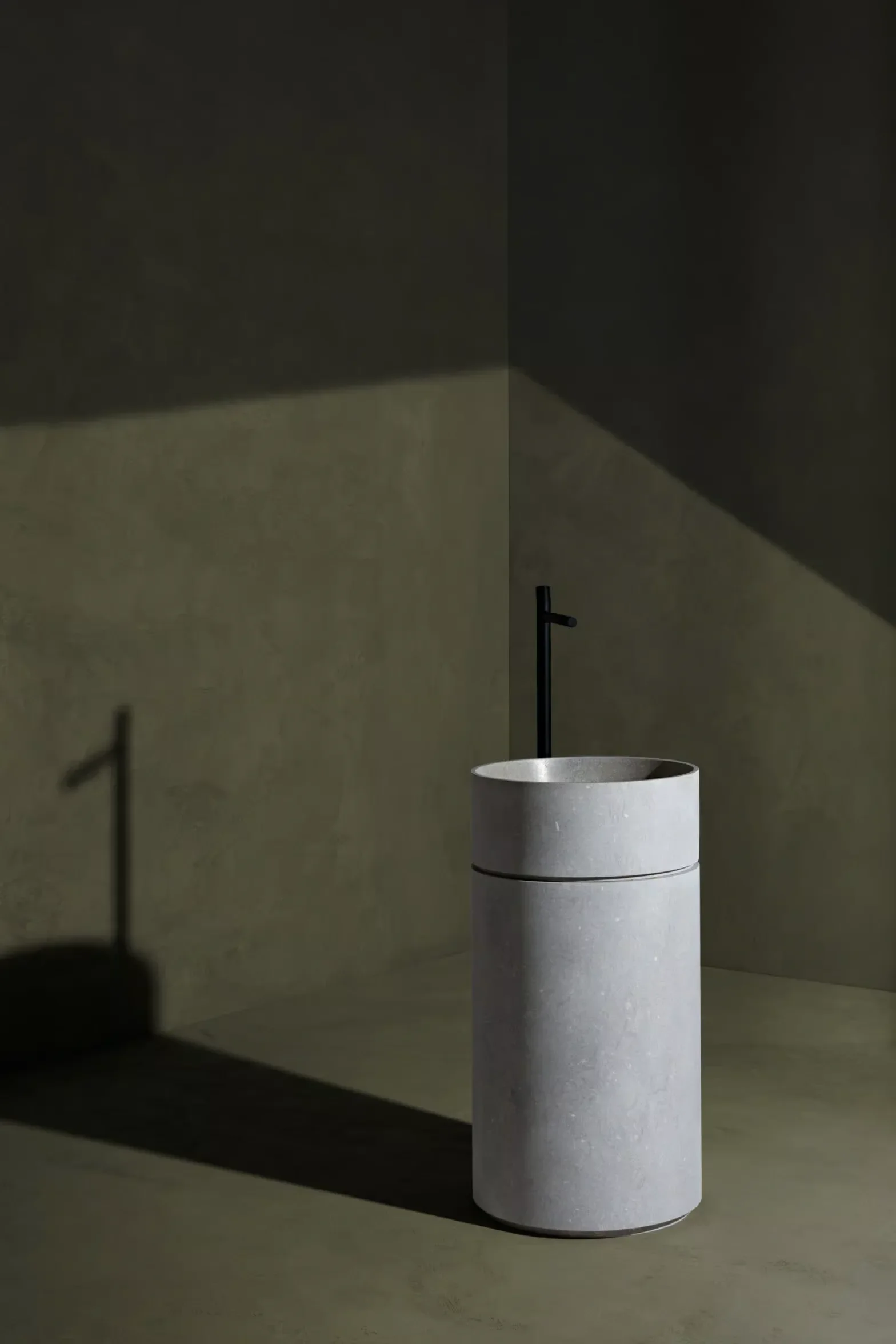 The Clarity freestanding washbasin by the luxury brand Kreoo, distinguished by the elegant horizontal line carved into its cylindrical body, available through PietraCasa.
