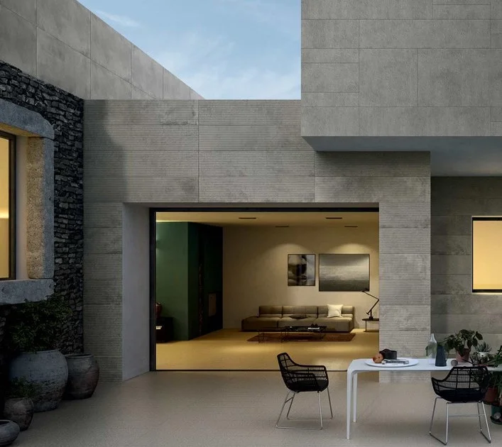 Modern exterior facade featuring textured, stone-effect tiles from the Florim Matrice collection, expertly supplied and installed by PietraCasa.