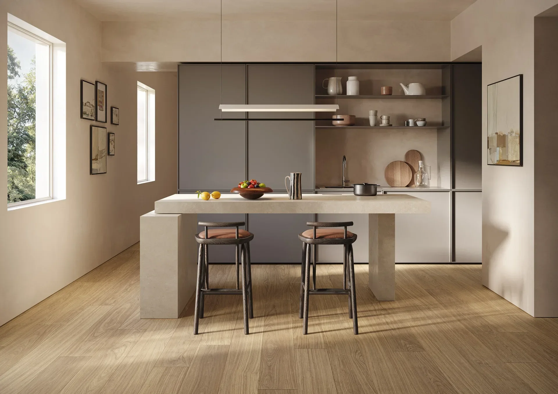 Minimalist, open-plan kitchen space featuring the Marazzi Nobilis collection, highlighting versatile porcelain stoneware and wood-effect surfaces for seamless continuity between floors and walls, available through PietraCasa.