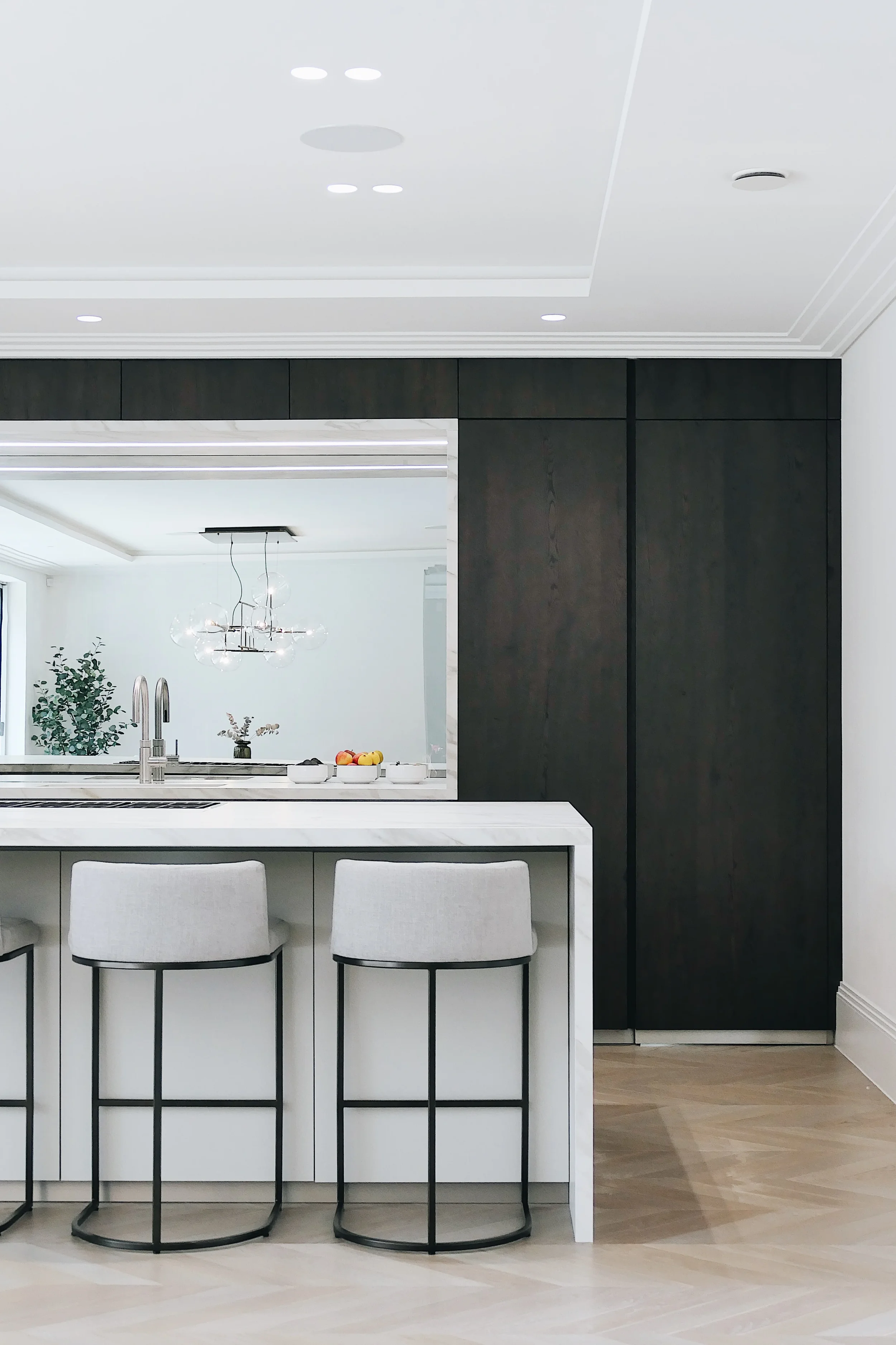 Bespoke kitchen island worktop and waterfall profile custom fabricated from white marble-look porcelain slabs.