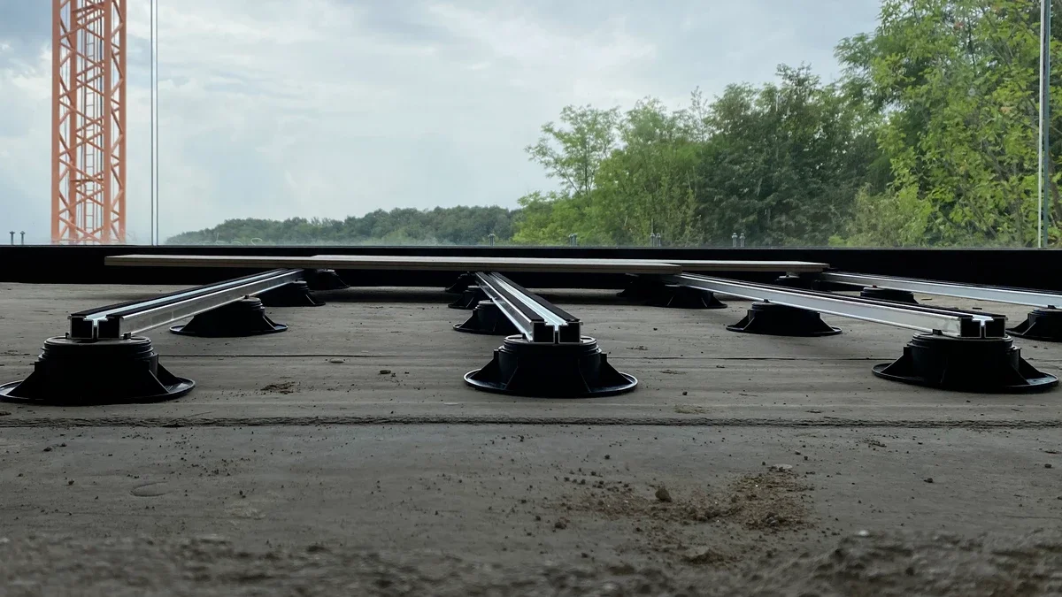 View of Eterno Ivica adjustable pedestals supporting a metal joist system for raised outdoor decking, professionally supplied and installed by PietraCasa.