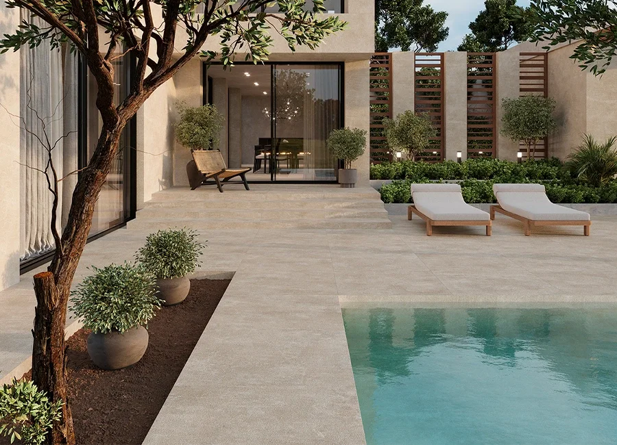 Modern minimalist patio and pool deck surfaced with Inalco Amara large-format porcelain slabs, designed for seamless indoor-outdoor living, exclusively distributed in the UK by PietraCasa.
