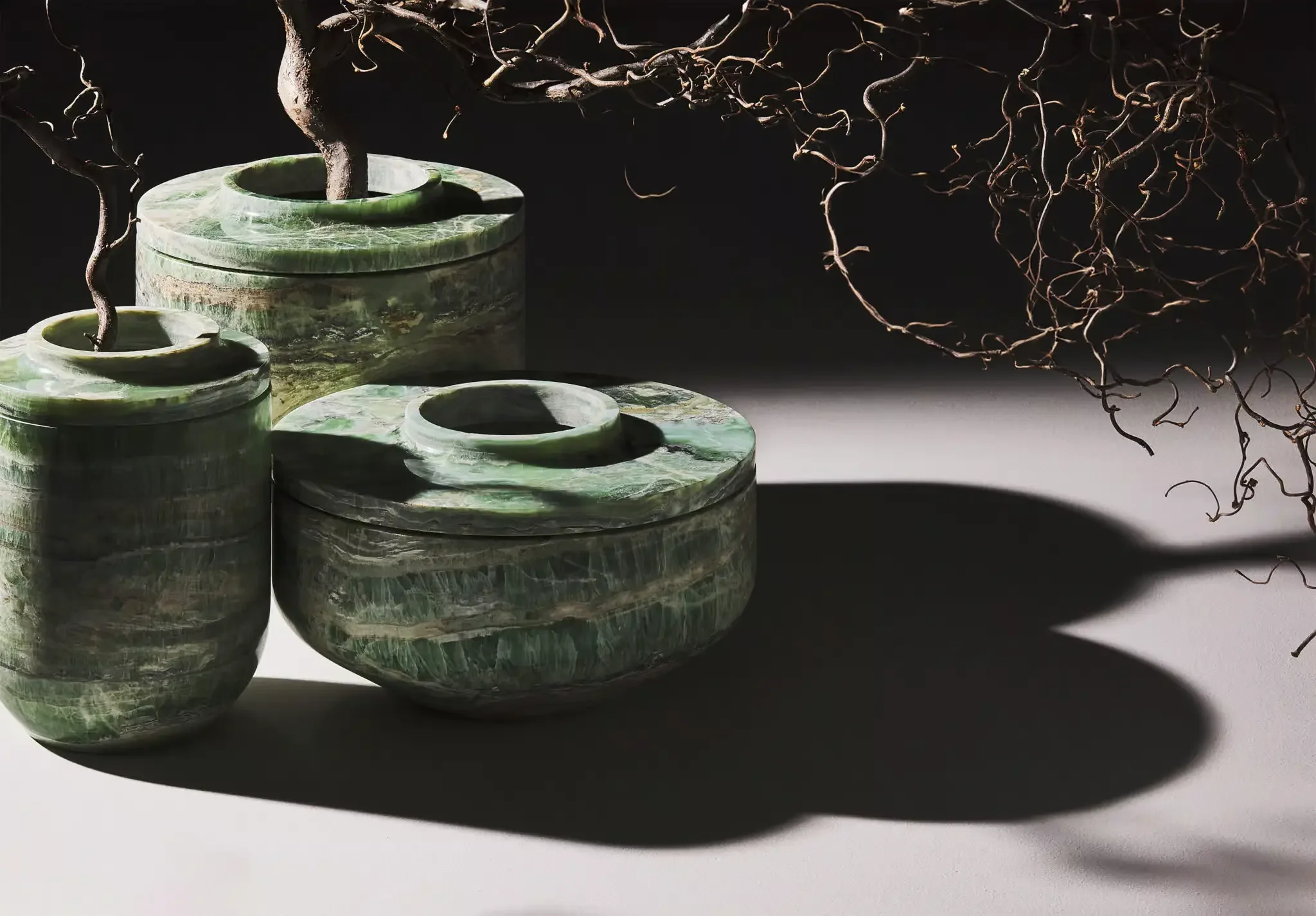 The Royal marble vase collection by Kreoo, designed by Christophe Pillet, featuring hand-carved solid marble with soft, rounded bases and a recessed lid creating a floating effect, available through PietraCasa.