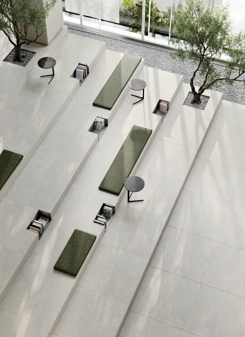 Interior space featuring Supergres Kalkarea stone-effect porcelain stoneware flooring in a light ivory/pearl tone, creating a bright, sophisticated atmosphere, supplied by PietraCasa.