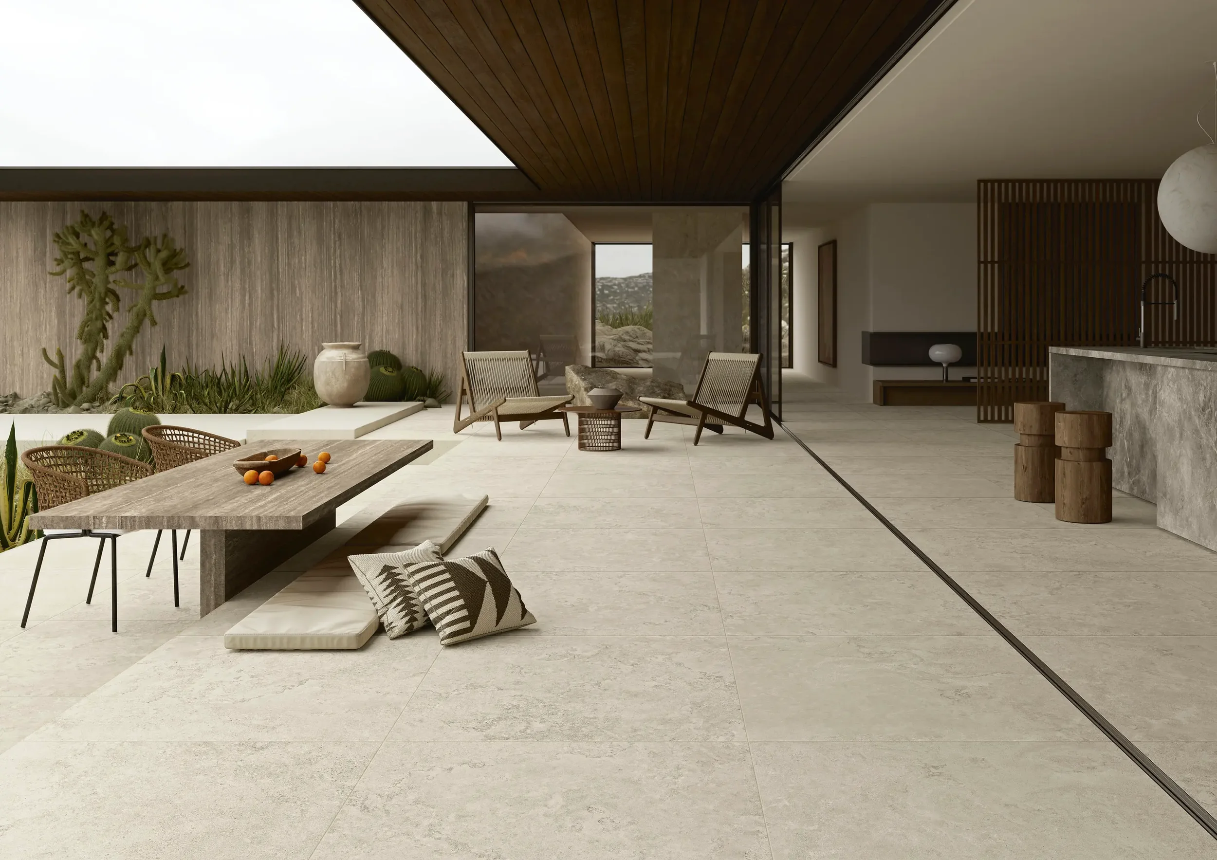 Seamless indoor-outdoor living space featuring versatile Ariostea Portland porcelain tiles with a natural stone effect, supplied and installed nationwide by PietraCasa.