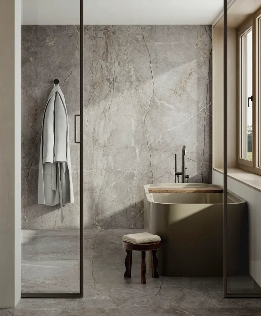 Modern bathroom interior featuring Fiandre Marmi Maximum Silver Root porcelain stoneware tiles, designed to mimic the appearance of shaded silvery marble with intricate grains and veins, supplied and installed by PietraCasa.