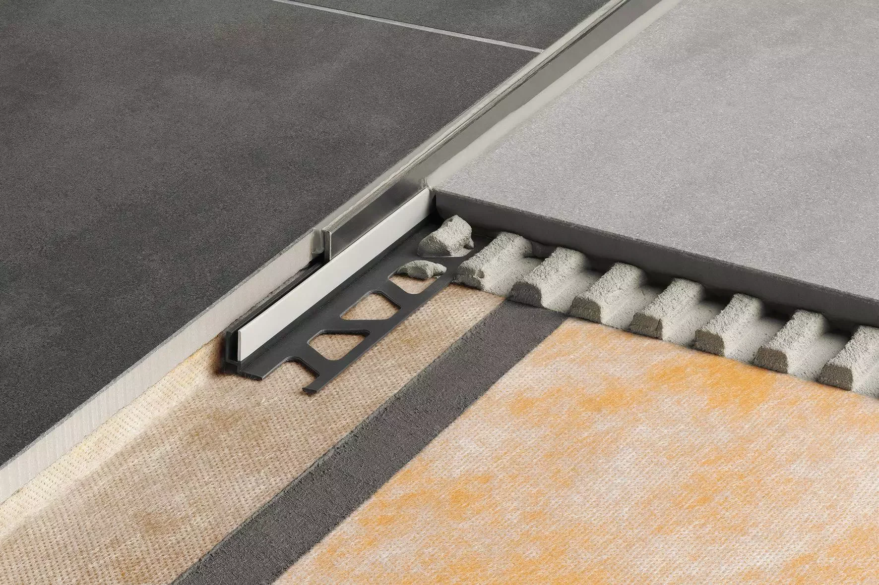 Close-up of the Schlüter-SHOWERPROFILE-S two-part tapered profile installed in a floor-level shower, expertly managed by PietraCasa.