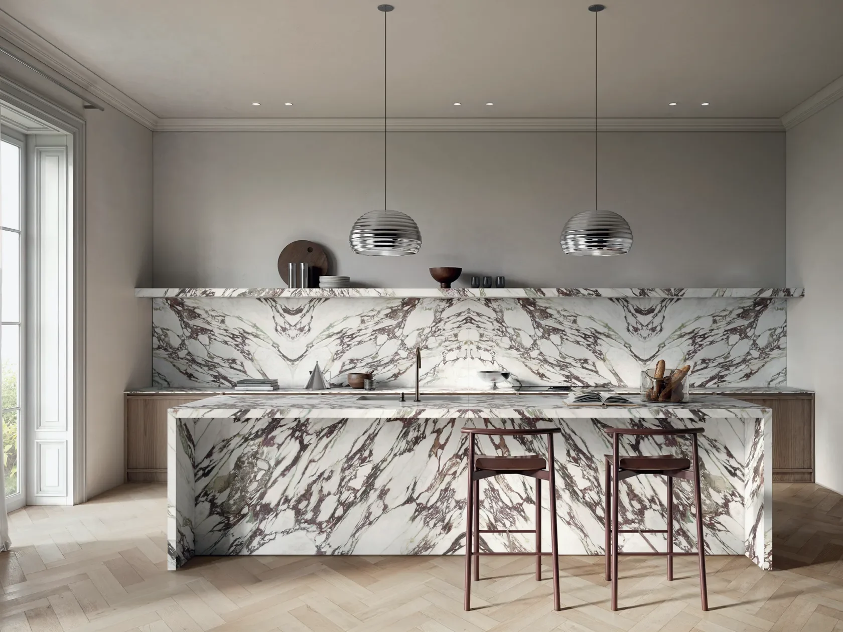 Modern kitchen interior featuring Italstone's Calacatta Vagli antibacterial porcelain stoneware slabs on the island and backsplash, available through PietraCasa.