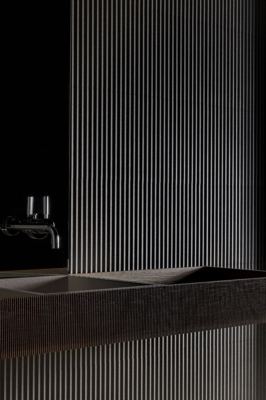 The Ground Ductile wall tile and coordinating grooved sink collection by Living Ceramics, characterized by a dramatic fluted texture, available through PietraCasa.
