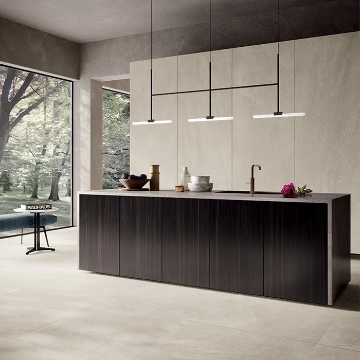 A modern kitchen setting featuring a high-end Italian porcelain collection by Lea Ceramiche, highlighting the seamless use of large-format stoneware for structural and custom furniture surfaces, available through PietraCasa.
