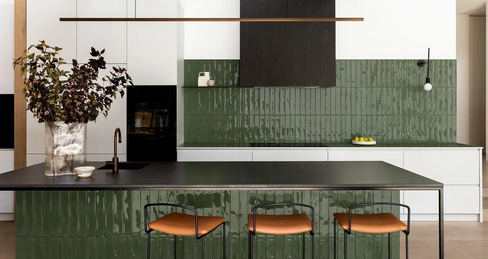 Kitchen featuring Marazzi Luz Lux ceramic tiles in the color Oliva, part of the artisanal Crogiolo collection, applied to the backsplash and island, available through PietraCasa.