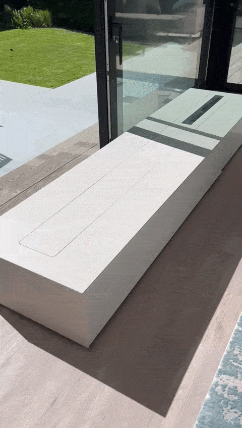 A sophisticated, modern media solution featuring a hidden, motorized pop-up television, seamlessly blending high-tech functionality with a clean, minimalist interior aesthetic.