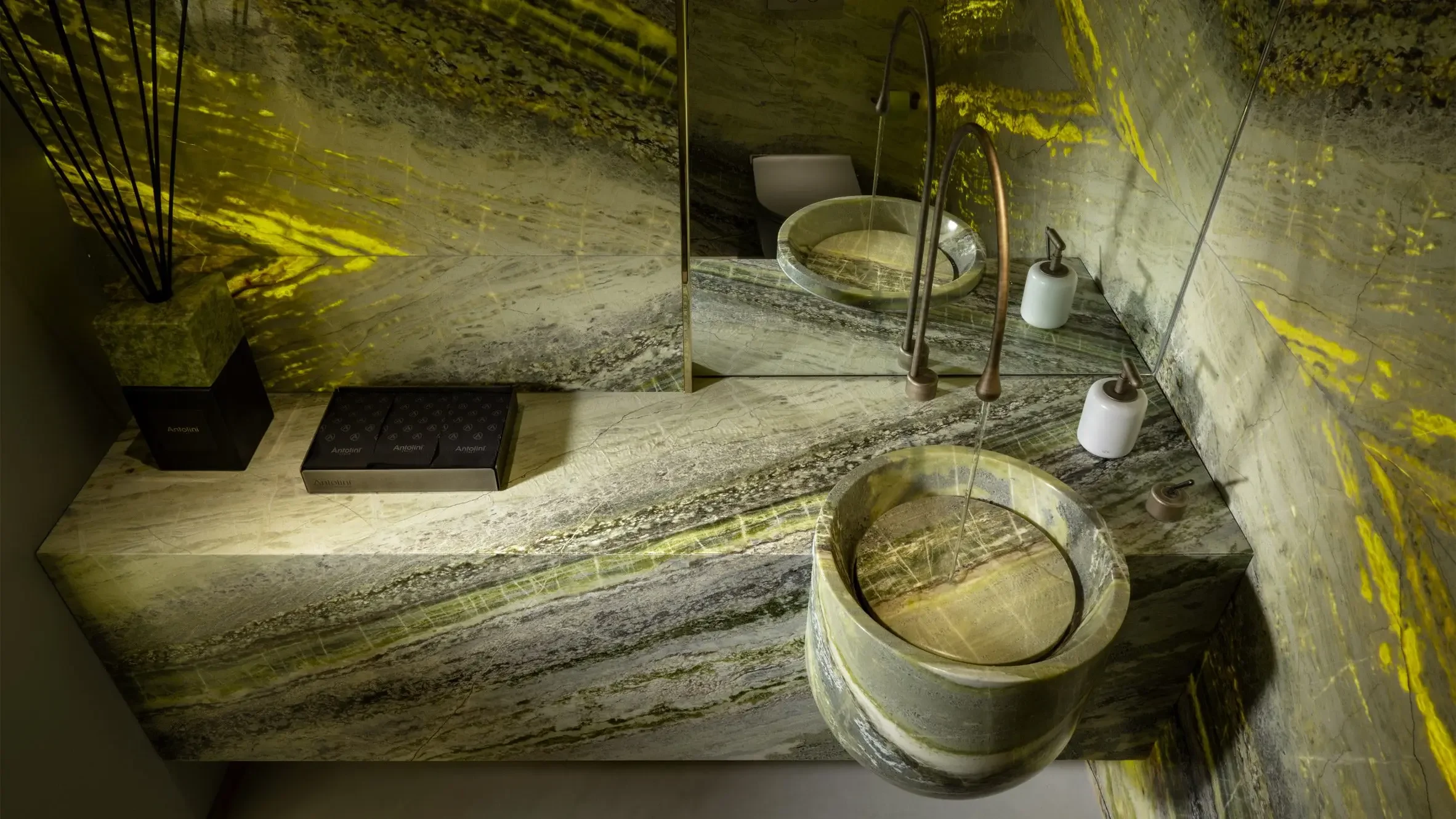 Bathroom vanity featuring the vivid green and white veining of Irish Green marble, designed by Alessandro La Spada for Antolini, supplied by PietraCasa.