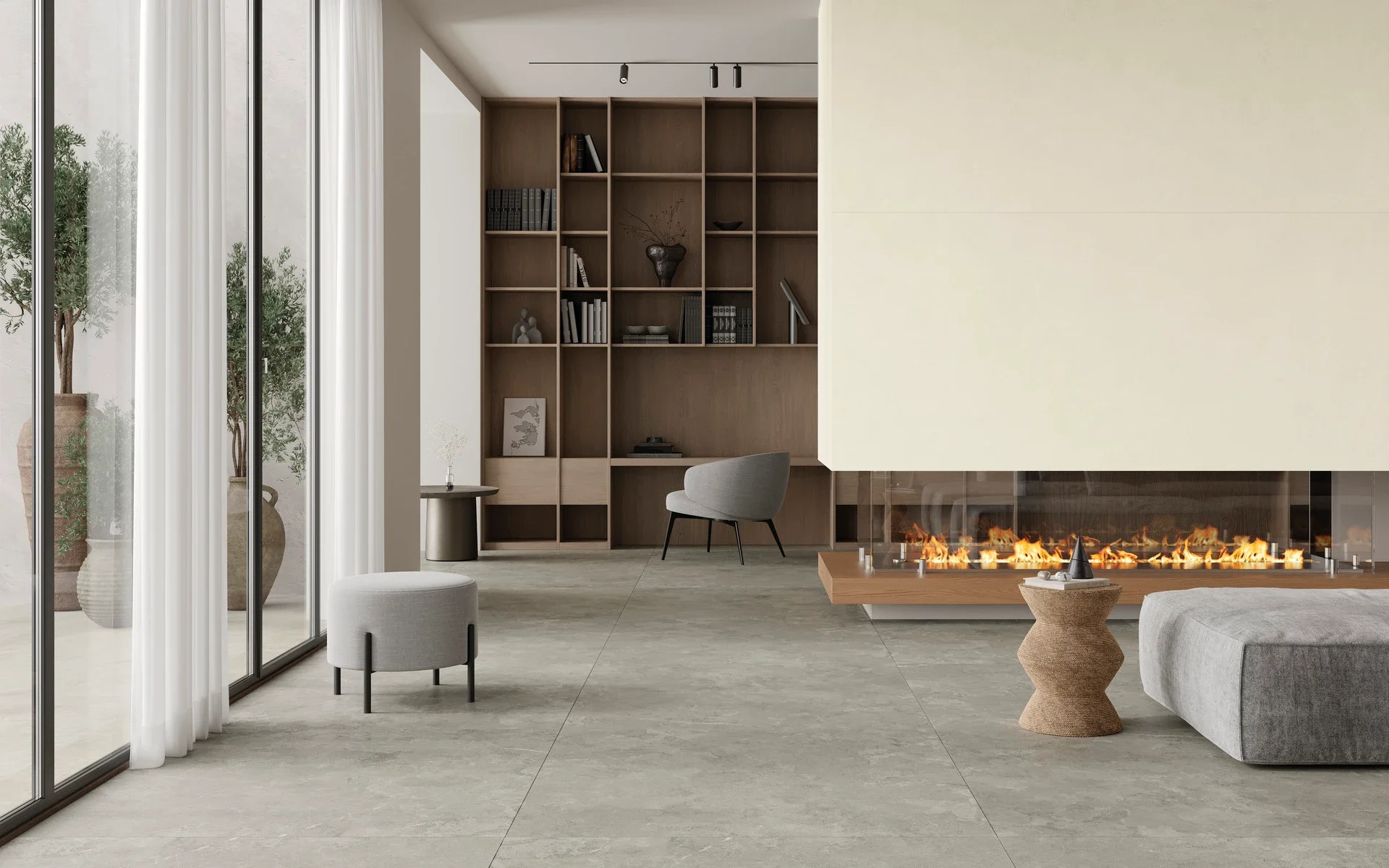 Modern living space featuring Iris Ceramica's Pietra di Sciara porcelain stoneware, presented in a sleek, large-format tile that mimics natural stone, available through PietraCasa.