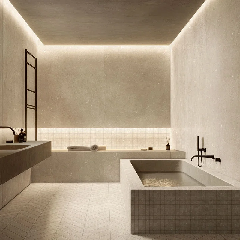 Minimalist bathroom featuring the Norlith ceramic collection in sandstone beige by Terratinta Group, with custom porcelain surfaces and a recessed soaking tub, supplied by PietraCasa.