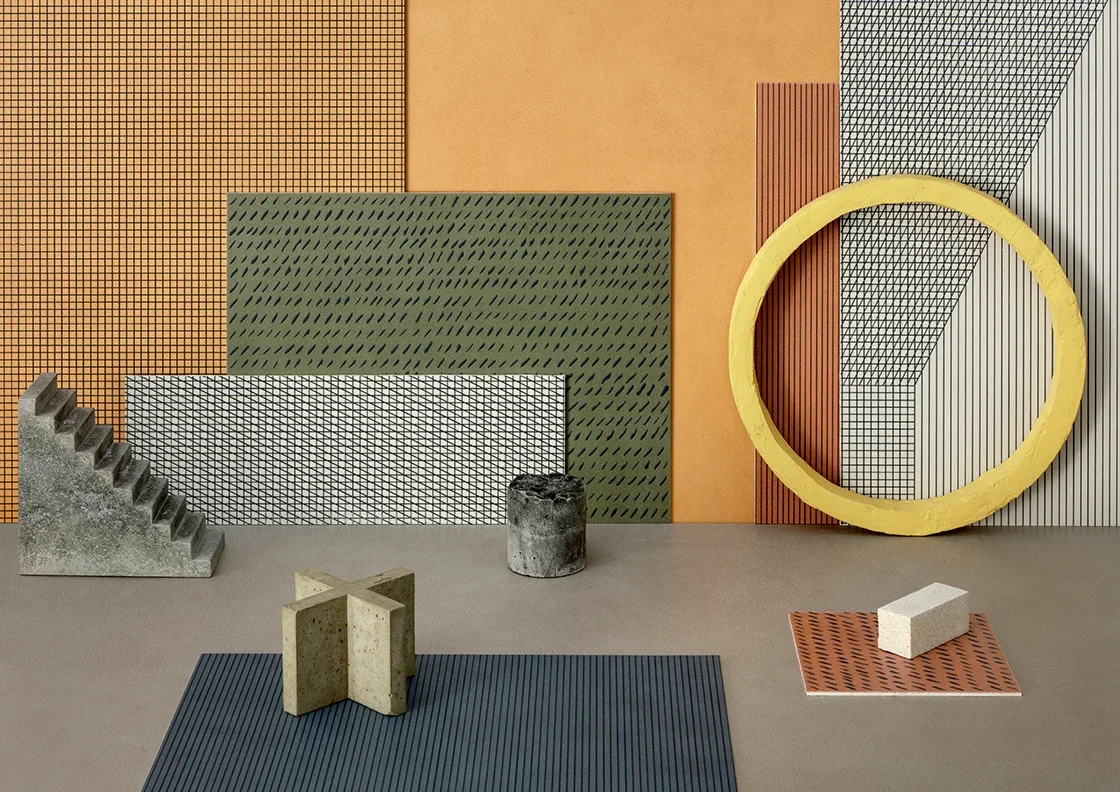 The Segni su Pigmenti ceramic collection by Lea Ceramiche, designed by Ferruccio Laviani, showcasing expressive geometric and abstract graphics on ultra-thin laminated porcelain, available through PietraCasa.