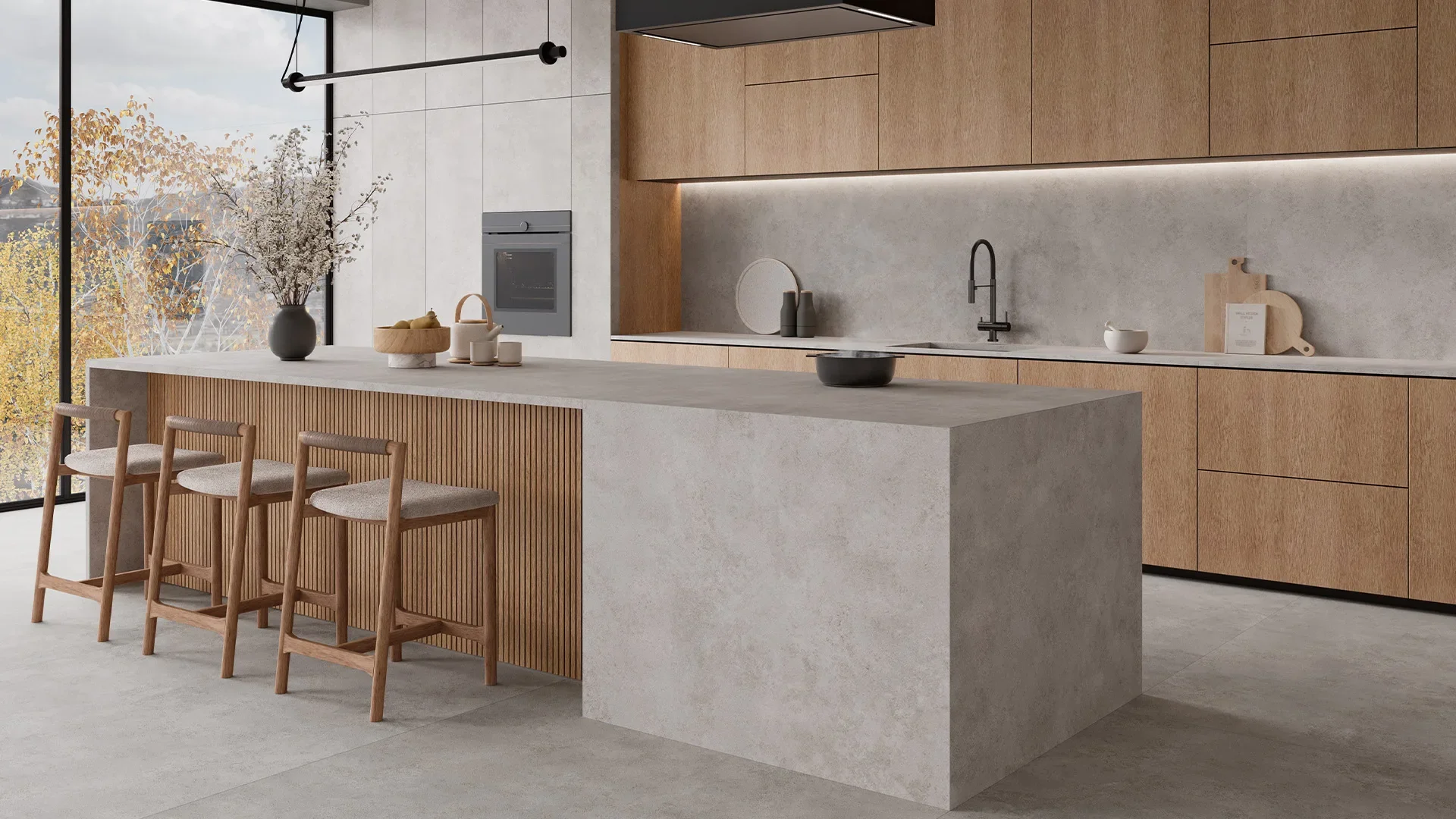 Modern kitchen featuring an Inalco ARES MDi island and worktop, highlighted by elegant wooden fluting on the breakfast bar and light timber cabinetry overhead, exclusively distributed in the UK by PietraCasa.
