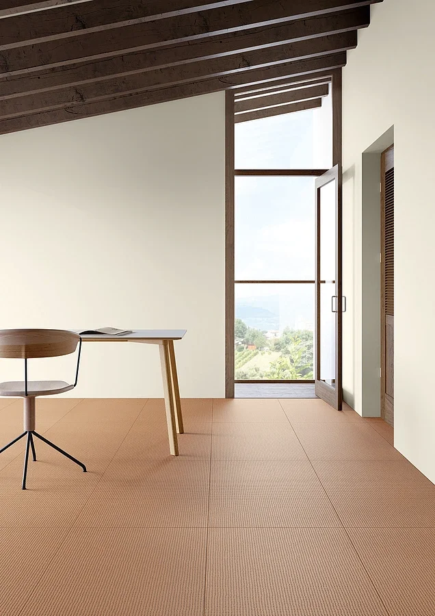 Minimalist interior featuring flooring from the Mutina Pico collection, designed by Ronan & Erwan Bouroullec, showcasing a fine, textured finish, available through PietraCasa.