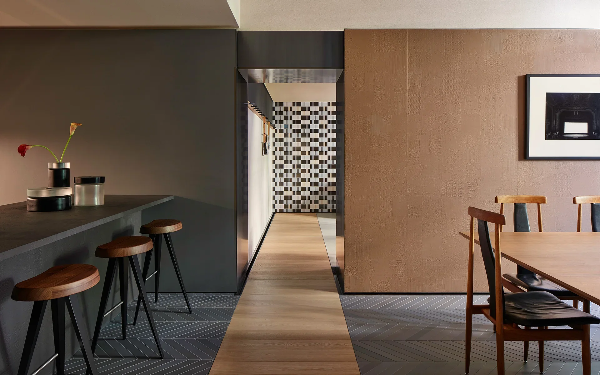 Dining and kitchen area within the Casa Mutina Milano showroom, showcasing sophisticated interior design by Patricia Urquiola, featuring premium surfaces available through PietraCasa