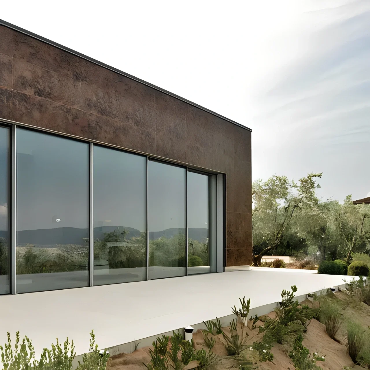 A contemporary villa facade clad in Laminam large-format ceramic slabs, showcasing minimalist architecture and expansive glass, available through PietraCasa.